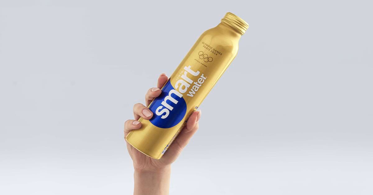 image of a hand holding a gold SmartWater bottle in the air