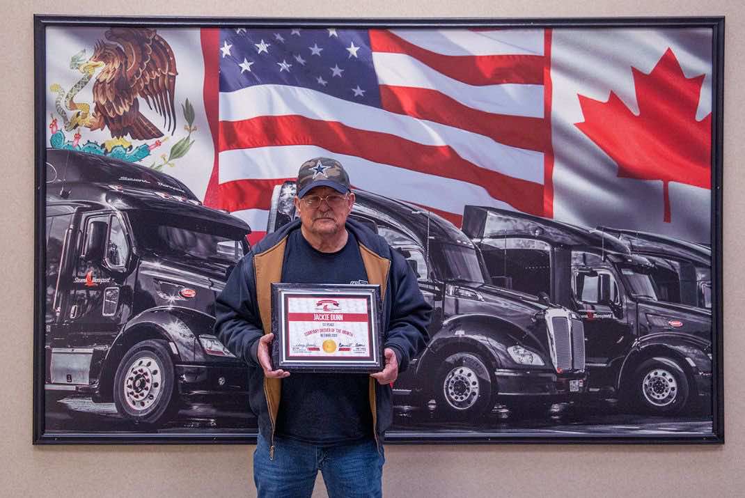 Image of Jackie Dunn holding award
