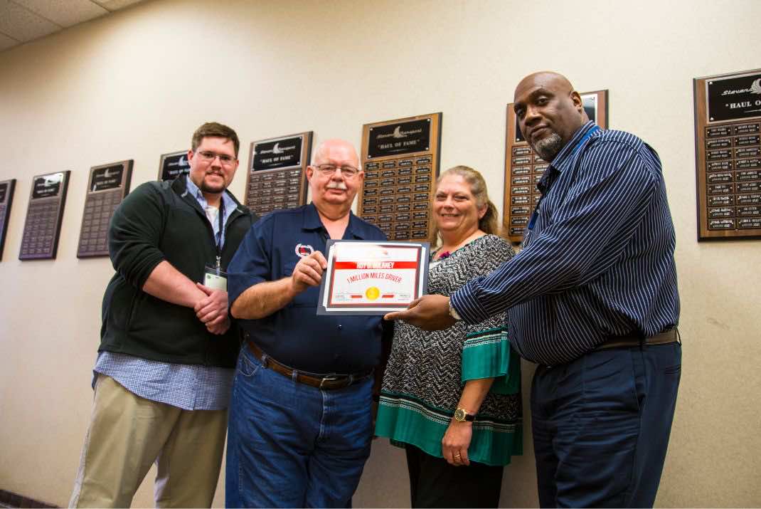 Image of group of people, Roy Dulaney holding Million Miler award