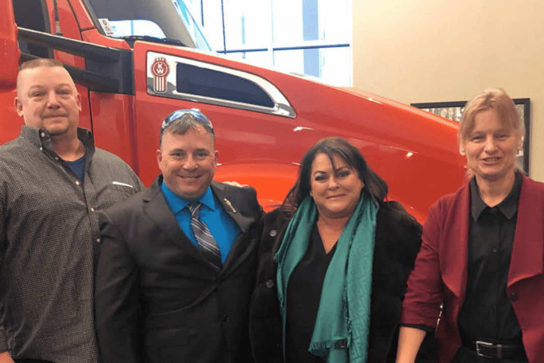 image of Stevens Transport team in front of Transition Trucking Kenworth truck